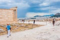 The Southern corner of Erechtheion or Erechtheum temple honoring Athena & Poseidon on Acropolis hill with walking around people Royalty Free Stock Photo