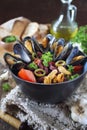 Southern cuisine of Italy. Calabria food. Soup with mussels, tomatoes and red beans, parsley dressing