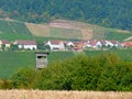 Southern german landscape with vineyard and a farming village and a hunter high seat in the foreground