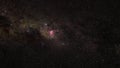 Southern night sky, many stars with milky way around Crux and Vela constellation, red purple Great Carina Nebula in