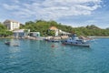 Southern port area, ship and boat parking in a bay, buildings, coastline, amidst tropical greenery, blue sky and clouds, Vietnam