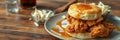 Southern style chicken and biscuit stack with syrup served on a wooden table Royalty Free Stock Photo