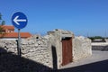 Southern town street with old stone fence and road sign