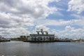 The Southern Yacht Club with ocean water, lush green trees and grass, boats and yachts, blue sky and clouds in New Orleans Royalty Free Stock Photo