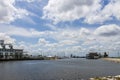 The Southern Yacht Club with ocean water, lush green trees and grass, boats and yachts, blue sky and clouds in New Orleans Royalty Free Stock Photo