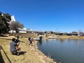 Reporter recording community fishing event at neighborhood pond in Southlake, Texas, America