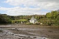 Southpool creek with houses and hilly fields in Devon