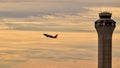 Southwest Airlines Boeing B737 flying in the distance with control tower in front. Royalty Free Stock Photo