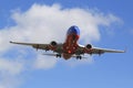 Southwest Airlines jet descending for landing San Diego International Airport. Royalty Free Stock Photo