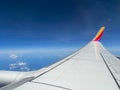 Southwest airplane wing flying above the clouds
