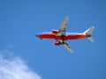 Southwest Plane flies overhead with wheels dropped Royalty Free Stock Photo