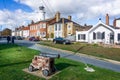 Southwold`s iconic lighthouse seen behind houses with cannon in foreground in Southwold, Suffolk, UK