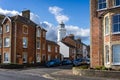 Southwold`s iconic lighthouse seen behind houses in Southwold, Suffolk, UK