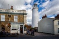 Southwold`s iconic lighthouse seen behind The Sole Bay Inn pub in Southwold, Suffolk, UK