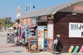 A souvenir, ice cream, juice and beach supplies store on the Larnaca Boardwalk. Finikoudes area. In the background is a monument