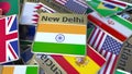 Souvenir magnet or badge with New Delhi text and national flag among different ones. Traveling to India conceptual 3D