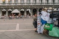 Souvenir merchant carrying his cart in Piazza San Marco in Venice, Italy