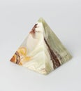 Souvenir, onyx pyramid, on white background
