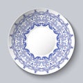Souvenir porcelain plate with a blue floral pattern. Royalty Free Stock Photo