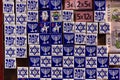 Souvenir shop display with colorful fridge magnet tiles with Jewish symbols, Toledo, Spain.