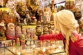 Souvenir shop in the old Arbat Moscow. blonde girl chooses souvenir