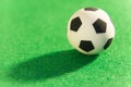 Souvenir soccer ball on a green background. A symbol of football. Macro. Super close-up. Royalty Free Stock Photo