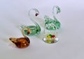 Souvenir swans made of glass with colorful eggs made of glass