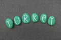 Turkey, country name with green colored stones over black volcanic sand Royalty Free Stock Photo