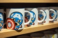 MINSK, BELARUS - December 20, 2019: Ceramic mugs on a shelf in the Miniso store with images of Captain America Marvel superheroe.