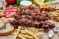 Souvlaki, meat skewers, traditional greek turkish meat food on pita bread and potatoes Royalty Free Stock Photo