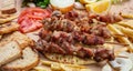 Souvlaki, meat skewers, traditional greek turkish meat food on pita bread, tzatziki sauce and potatoes Royalty Free Stock Photo