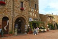 Tourists relax in outdoor cafe on central square of Sovana, Tuscany, Italy