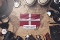 Sovereign Military Order of Malta Flag Between Traveler`s Accessories on Old Vintage Map. Overhead Shot