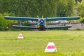 Soviet aircraft biplane Antonov AN-2 parked on a green grass of airfield Royalty Free Stock Photo