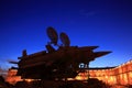 Soviet anti-aircraft missile launcher and military antenna against backdrop of the Arsenal building and dark blue evening sky Royalty Free Stock Photo