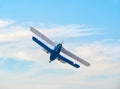 A soviet Antonov An-2 single-engine biplane flying against blue sky
