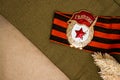 Soviet Bage ÃÂ«GuardÃÂ» and St. George ribbon, dried flowers and bullet on craft background