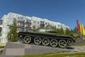 Soviet caterpillar tank T 54 in a green color. Monument. Side view.