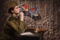 Soviet female soldier in uniform of World War II writes a letter Royalty Free Stock Photo