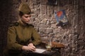 Soviet female soldier in uniform of World War II writes a letter Royalty Free Stock Photo