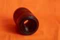 Soviet manual camera lens on orange background