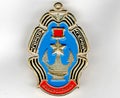 Soviet metal badge with the image of a gold star, anchors and the inscription in Russian `Novorossiysk-hero city`