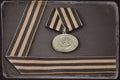 Soviet military medal and George ribbon, antique toned Royalty Free Stock Photo