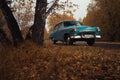 Soviet oldtimer Volga in the autumn forest