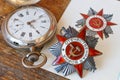 Soviet order of Patriotic war inscription Patriotic war with vintage pocket chronometer on an old wooden table. May 9 Victory da Royalty Free Stock Photo