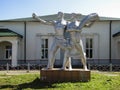 Soviet statue of worker and of collective farmer in front of the railway station building in Glazunovka, Oregl region, Russia.