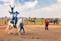 Young African children performing acrobatics on horse back