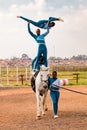 Young African children performing acrobatics on horse back