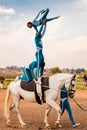 Young African children performing acrobatics on horse back