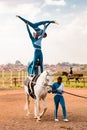 Young African children performing acrobatics on horse back